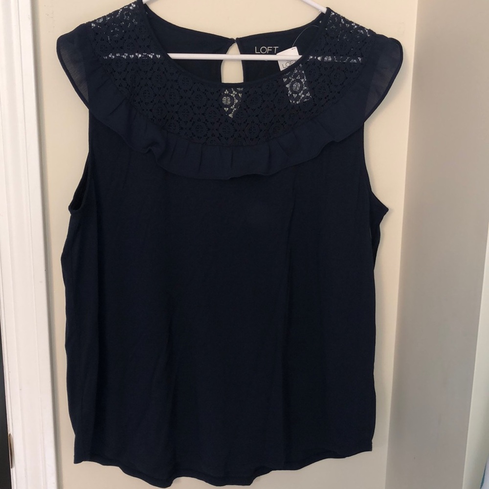 Navy top with detailed neckline.